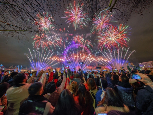 A crowd watching fireworks celebrating New Year's Eve