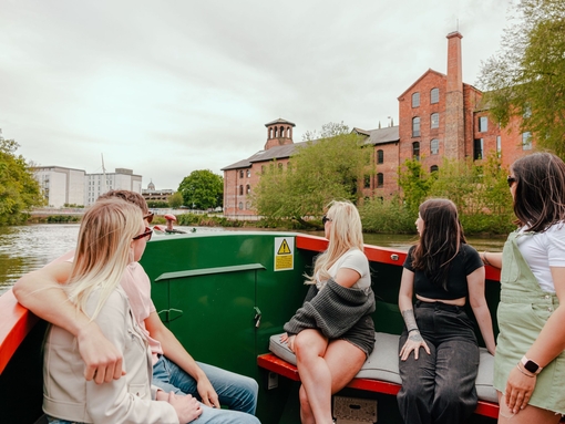 A group of people riding in a riverboat