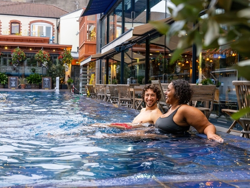 Man and woman relaxing in an outdoor swimming pool