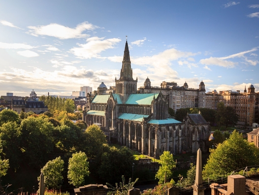 Aerial view of a cathedral on a sunny day with trees surrounding it