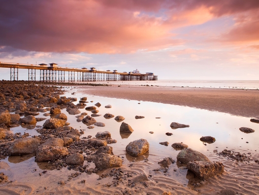Pier built out into the sea in grand Edwardian style at dusk
