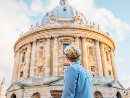 Man looking up at a historical building with dome