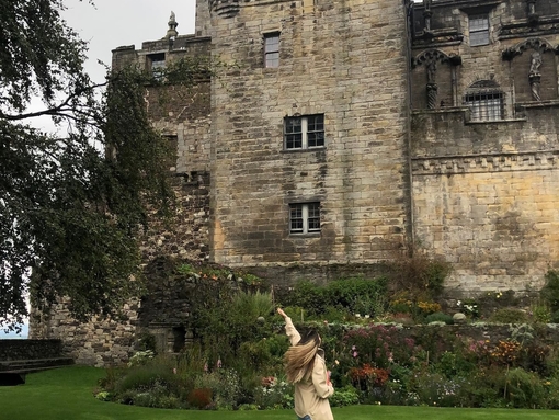 A woman posing in front of Stirling Castle, Scotland