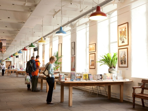 People browsing books and artwork at a gift shop