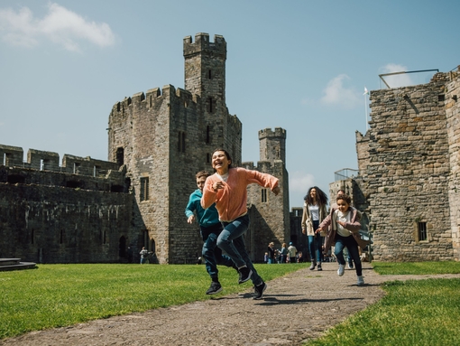 Kids running through the grounds of an old castle.