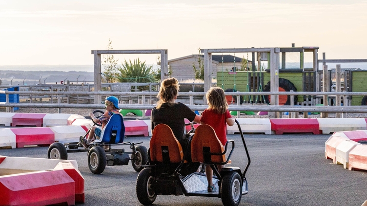 People racing in pedal go-karts