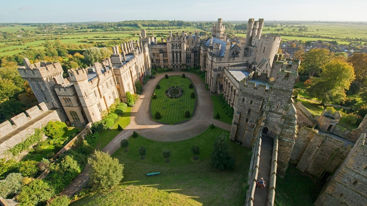 Aerial view of castle grounds. Grassy courtyard. Wide paths