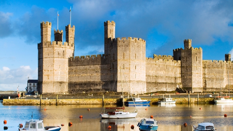 Row boats in a moat surrounding a castle