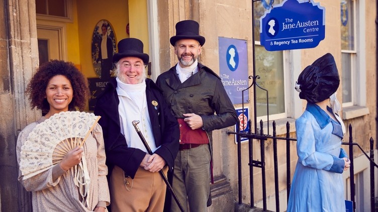 Visitors and staff in period costume outside The Jane Austen Centre, Bath, Somerset, England