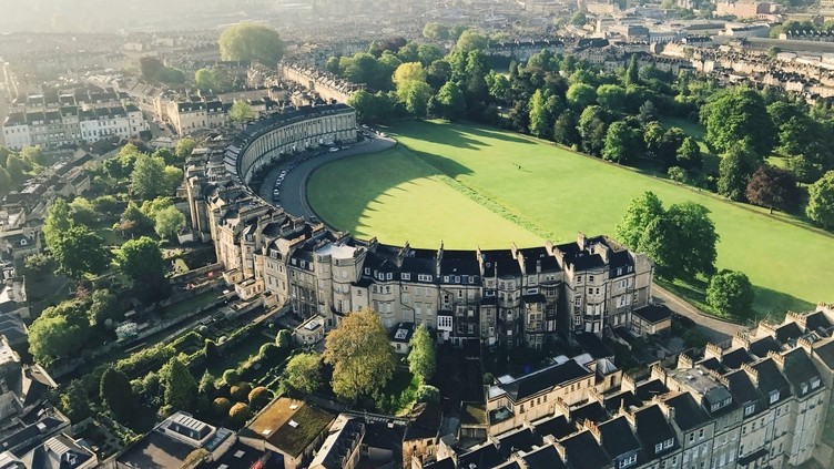 Aerial view of crescent-shaped building surrounded by grass