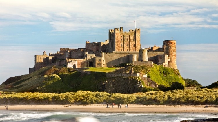 View from a distance of a castle on hill near a beach