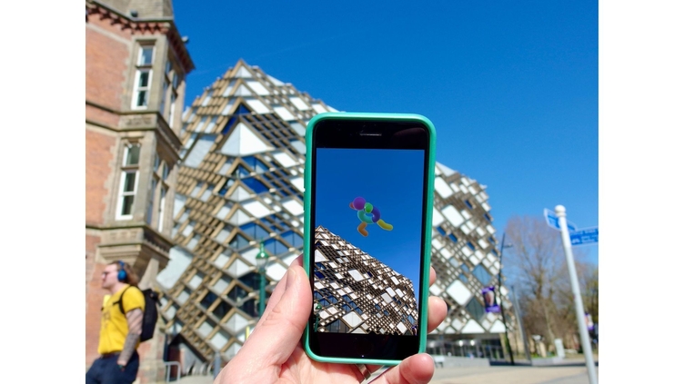 An artwork being viewed through a phone using AR technology in Sheffield