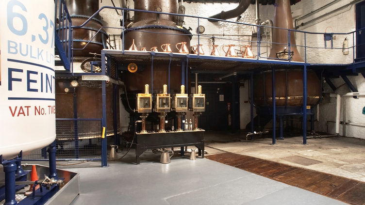 Distillery machines lining the wall at Plymouth Gin
