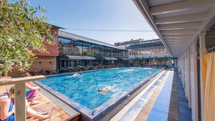 People swimming in an outdoor pool at Bristol Lido