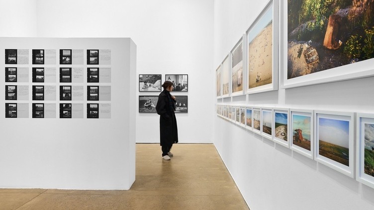 A woman admiring work at a photography exhibition.