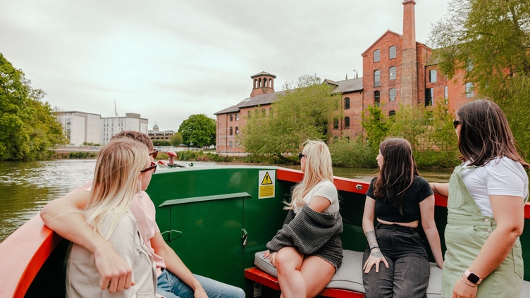 A group of people riding in a riverboat