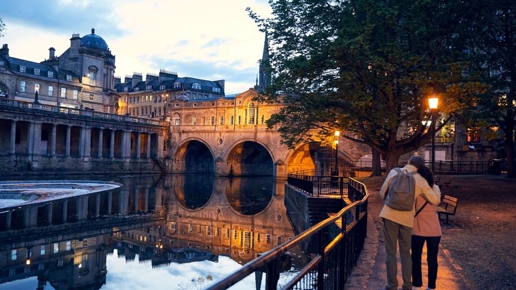Couple strolling beside a canal in the evening