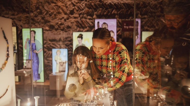 Mother and daughter looking at a display case in Colchester Castle museum