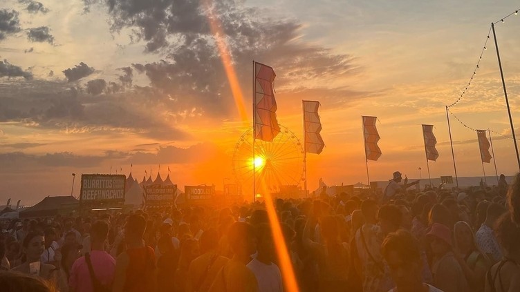 Sun setting over people at festival