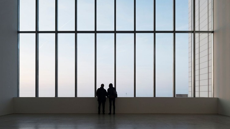 Two people looking out of a large window, Turner Contemporary
