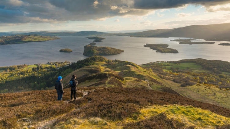 Walkers taking in the view of Loch Lomond from Conic Hill part of the West Highland Way
