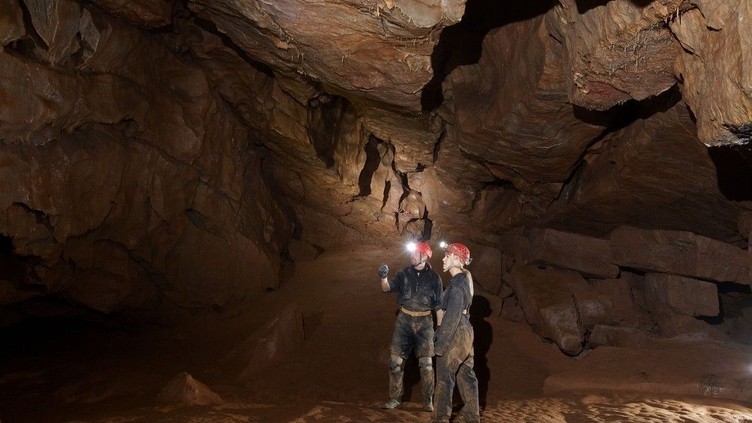 Two people caving at Cheddar Gorge Caves