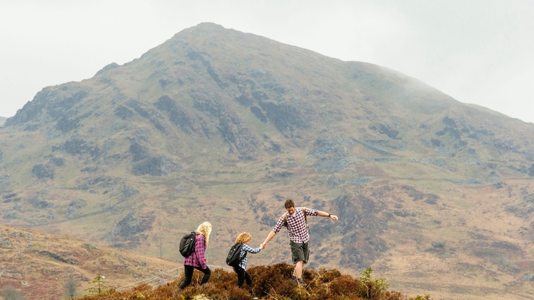Family hiking in the mountains on a cloudy day