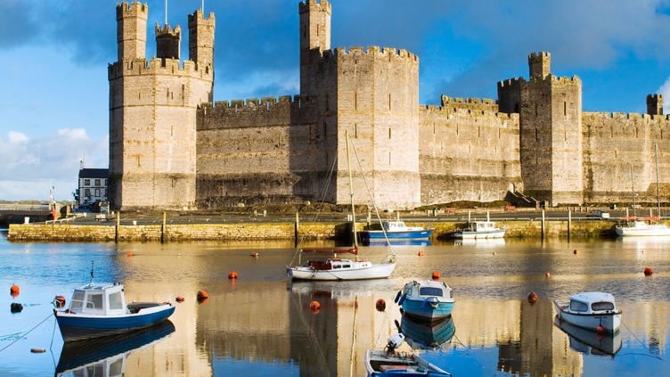 Row boats in a moat surrounding a castle