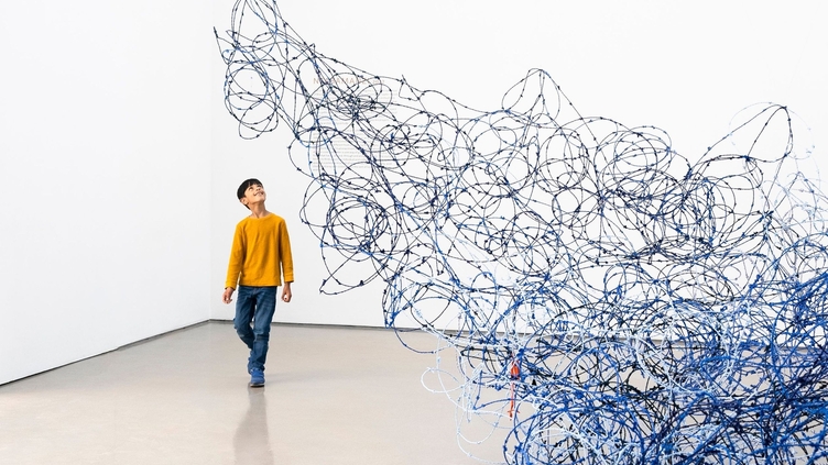 A child looking at an art exhibit in Leeds Art Gallery