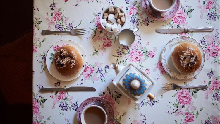 High angle close up of tea and buns on a table
