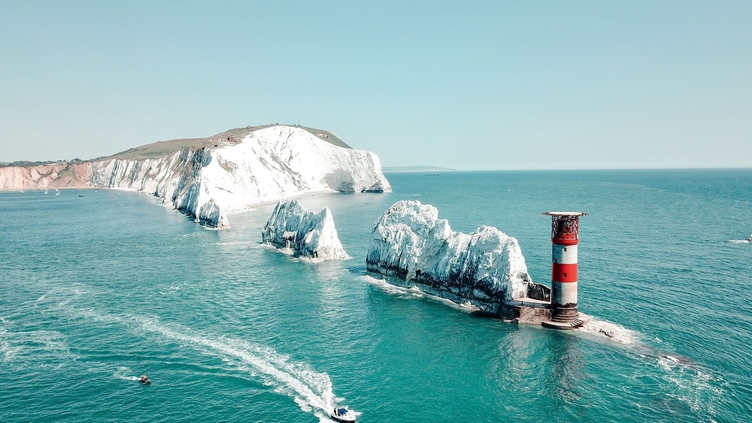 Aerial view of white rock formations standing tall from sea