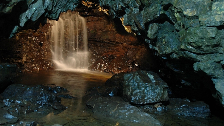 A waterfall cascade inside ingleborough cave in yorkshire, england