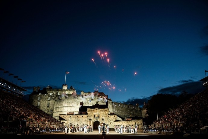 A performance of a military event in the grounds of a castle at night