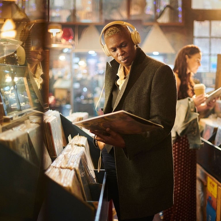 Adult browsing records in a vintage shop