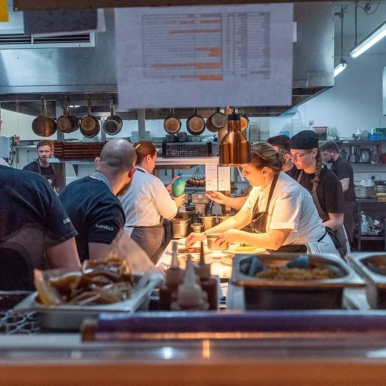 A group of chefs preparing food at Purnell's Restaurant in Birmingham