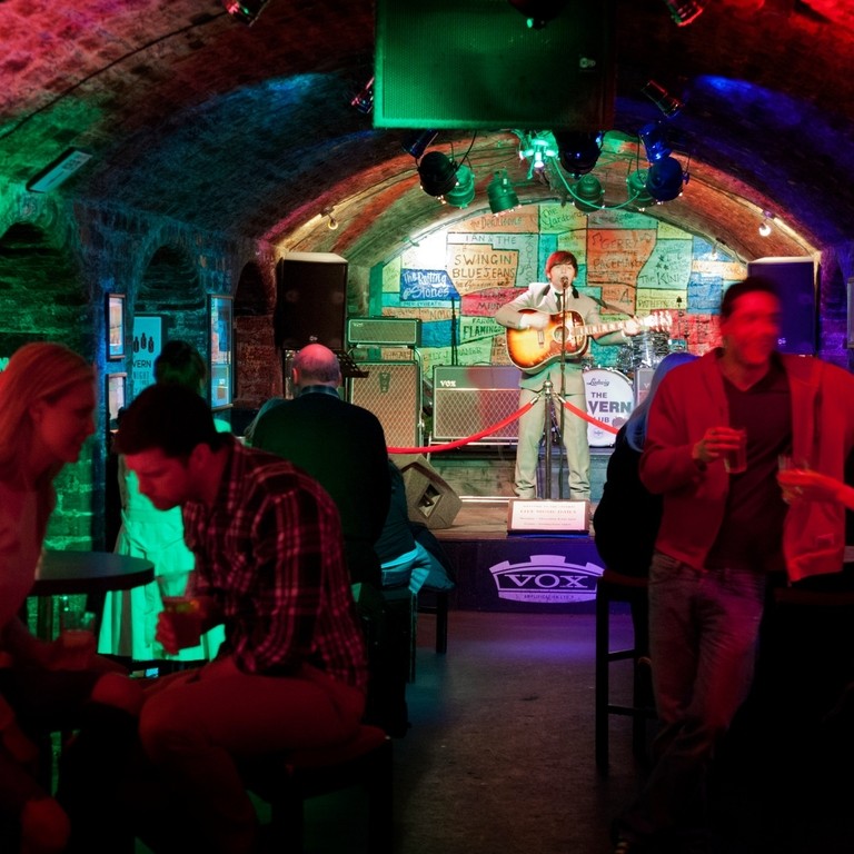 Inside club showing arched ceilings, coloured lights and stage, Liverpool