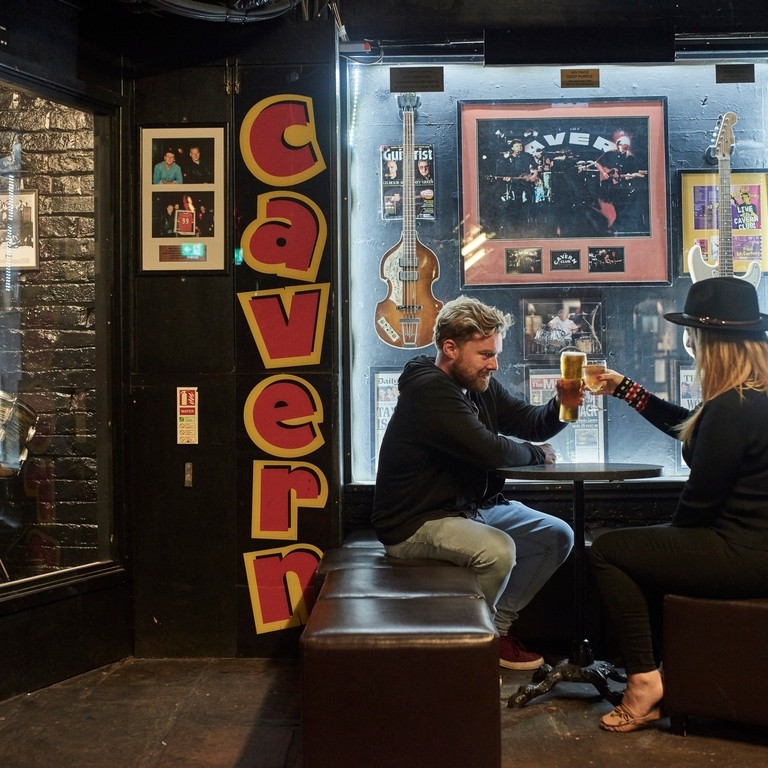 Man and woman toasting with white wine and beer