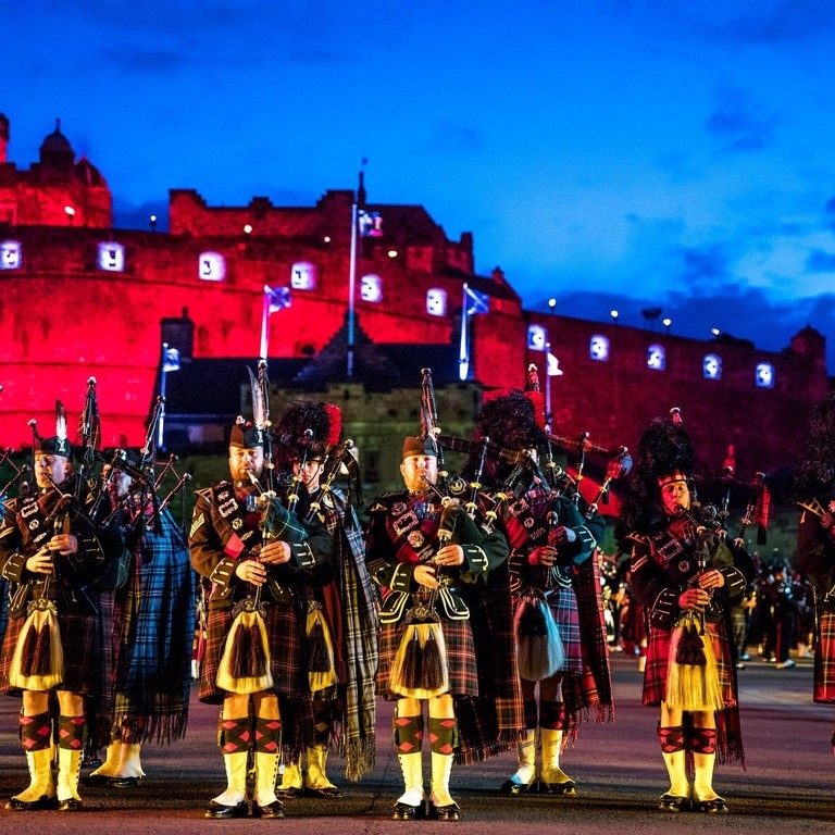 Marching band and light show projecting onto the castle