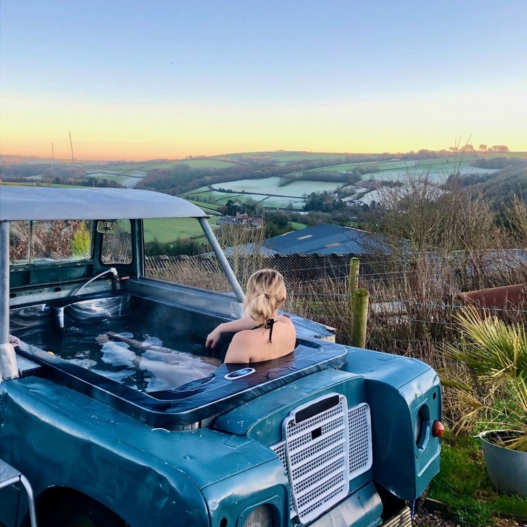 Rear view of woman sitting in a vehicle converted to hot tub
