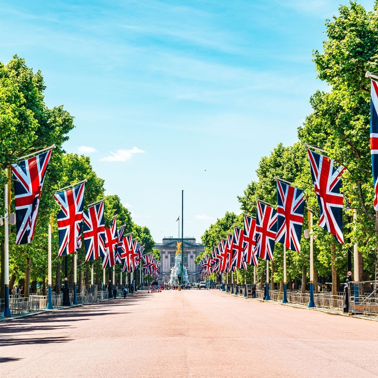 View to Buckingham Palace from the Mall showing union Jack flags