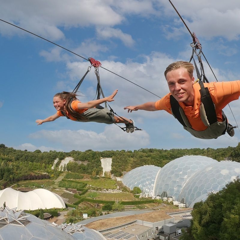 Two friends enjoying a zipline experience.