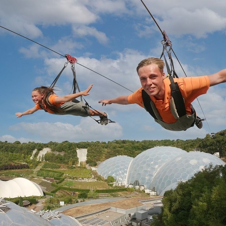 Two friends enjoying a zipline experience.