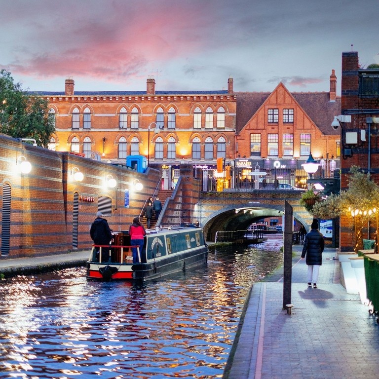 Riverboat on a canal. People walking down path
