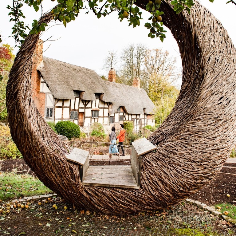 Crescent shaped bench outside Anne Hathaway's cottage, Stratford-upon-Avon.