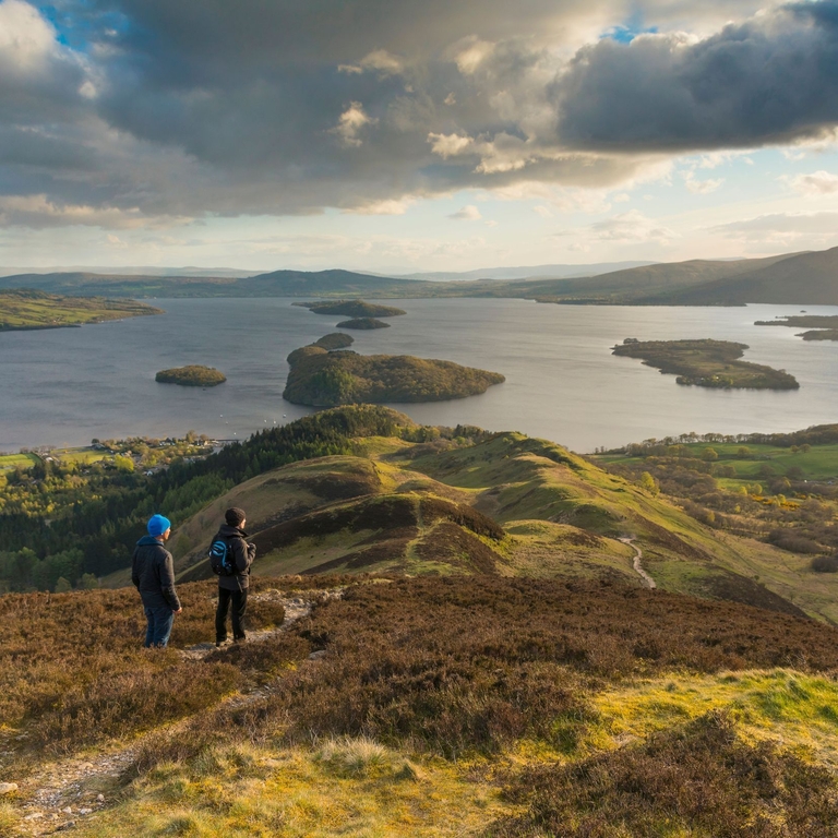 Walkers taking in the view of Loch Lomond from Conic Hill part of the West Highland Way