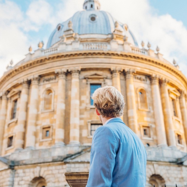 Man looking up at a historical building with dome
