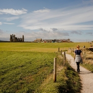 Woman walking along path between Whitby and Robin Hood's Bay.