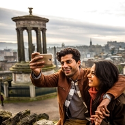 A young couple taking a selfie of view over historic town