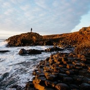 Sunset over the red basalt column. Sea views