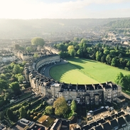 Aerial view of crescent-shaped building surrounded by grass